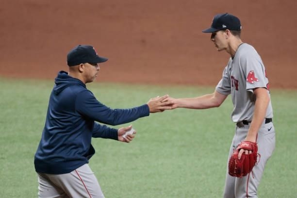 Alex Cora of the Boston Red Sox pulls Nick Pivetta of the Boston Red Sox from the game in the seventh inning during Game 1 of the American League...