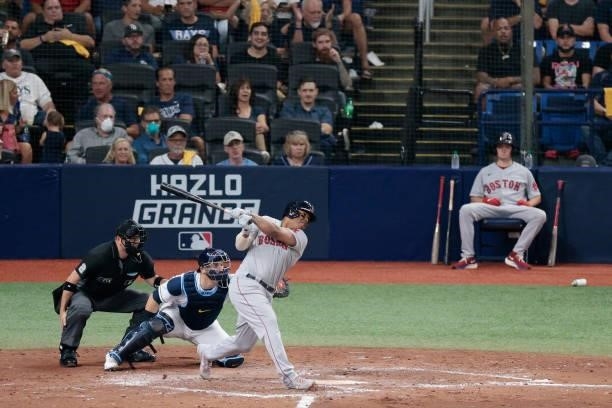 Rafael Devers of the Boston Red Sox hits a single in the fifth inning against the Tampa Bay Rays during Game 1 of the American League Division Series...