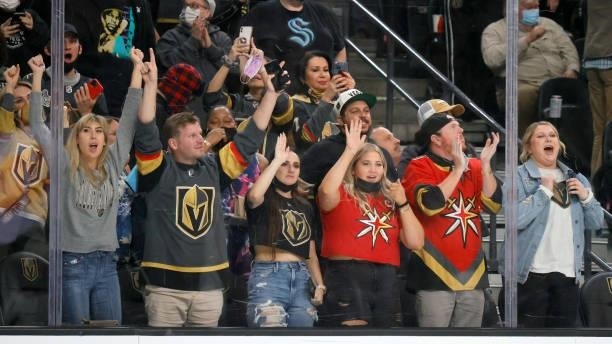 Fans celebrate a second-period power-play goal by William Karlsson of the Vegas Golden Knights against the Arizona Coyotes during their preseason...