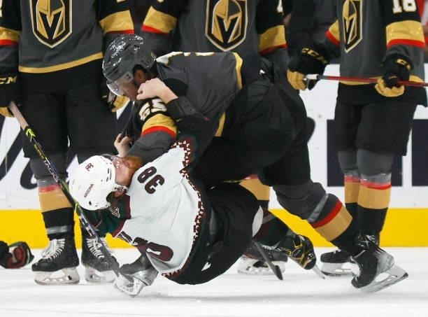 Keegan Kolesar of the Vegas Golden Knights and Liam O'Brien of the Arizona Coyotes fight in the second period of their preseason game at T-Mobile...