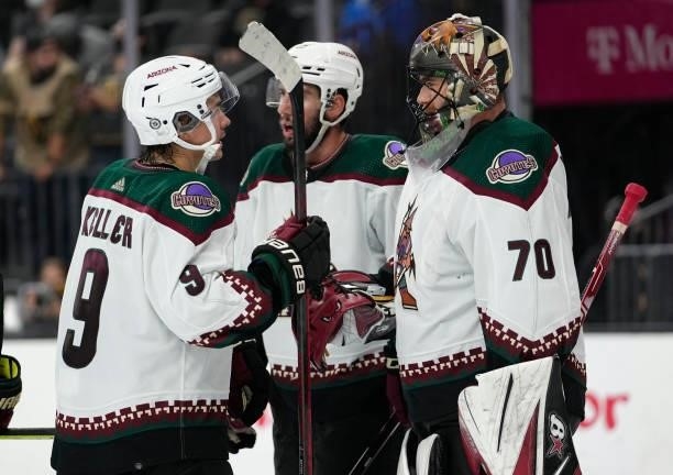 The Arizona Coyotes celebrate after defeating the Vegas Golden Knights at T-Mobile Arena on October 07, 2021 in Las Vegas, Nevada.