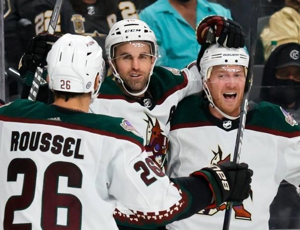 Antoine Roussel, Andrew Ladd and Travis Boyd of the Arizona Coyotes celebrate Ladd's third-period goal against the Vegas Golden Knights during their...