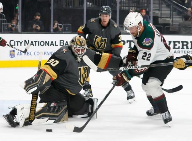 Johan Larsson of the Arizona Coyotes tries to put a rebound past Robin Lehner of the Vegas Golden Knights in the first period of their preseason game...