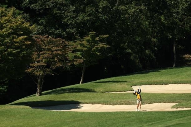 Minami Katsu of Japan hits her second shot out from a bunker on the 5th hole during the first round of the Stanley Ladies at Tomei Country Club on...