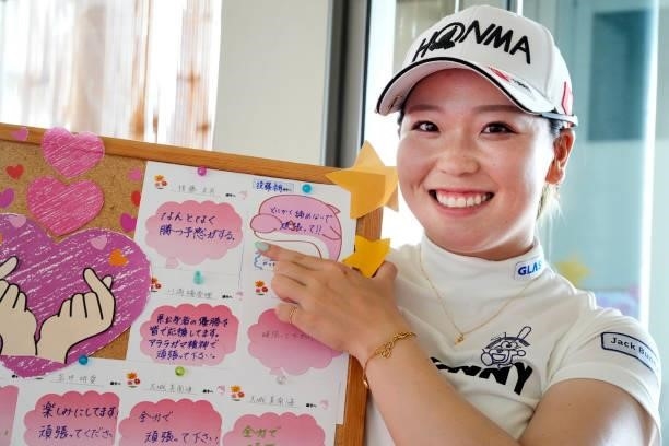 Miyu Goto of Japan poses with messages from fans after the second round of Kanehide Miyarabi Open at the Kanehide Kise Country Club on October 8,...