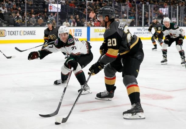 Chandler Stephenson of the Vegas Golden Knights skates with the puck against Victor Soderstrom of the Arizona Coyotes in the second period of their...