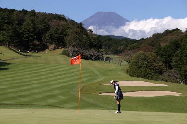 Kotone Hori of Japan holes the birdie putt on the 5th green during the first round of the Stanley Ladies at Tomei Country Club on October 8, 2021 in...