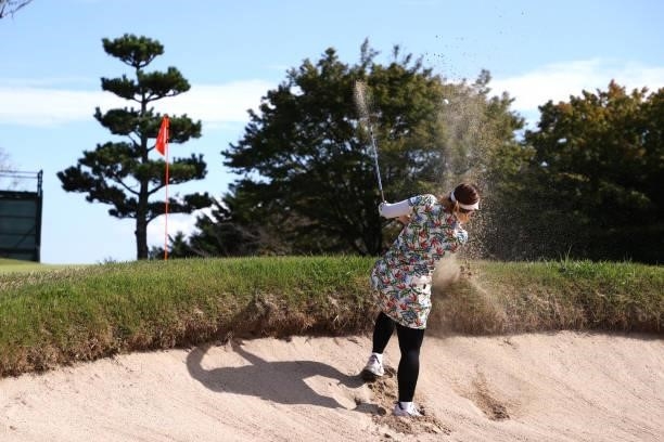Satsuki Oshiro of Japan hits out from a bunker on the 8th hole during the first round of the Stanley Ladies at Tomei Country Club on October 8, 2021...