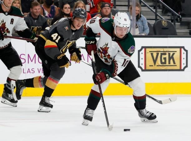 Ryan Dzingel of the Arizona Coyotes passes the puck ahead of Nolan Patrick of the Vegas Golden Knights in the second period of their preseason game...
