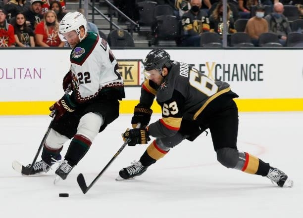 Evgenii Dadonov of the Vegas Golden Knights steals the puck from Johan Larsson of the Arizona Coyotes in the third period of their preseason game at...