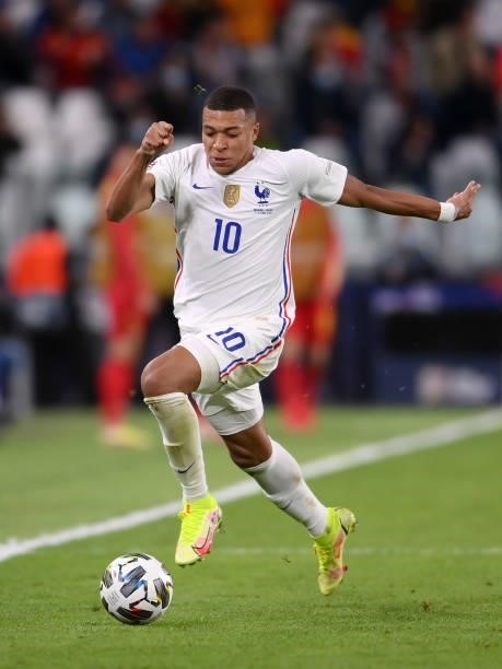 Kylian Mbappe of France runs with the ball during the UEFA Nations League 2021 Semi-final match between Belgium and France at Allianz Stadium on...