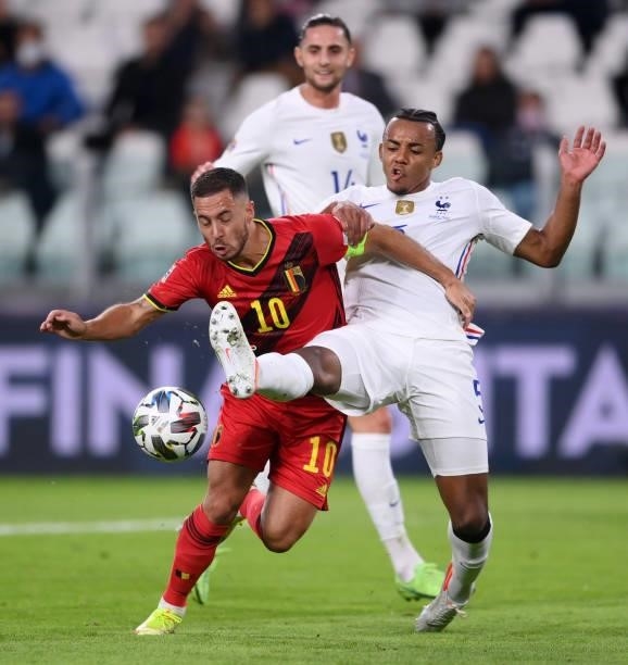 Eden Hazard of Belgium is tackled by Jules Koundee of France during the UEFA Nations League 2021 Semi-final match between Belgium and France at...