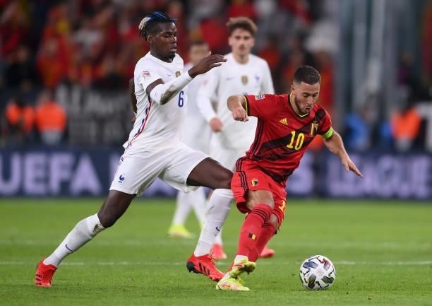 Eden Hazard of Belgium is tackled by Paul Pogba of France during the UEFA Nations League 2021 Semi-final match between Belgium and France at Allianz...