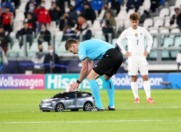 Referee Daniel Siebert of Germany picks up the Adidas official matchball from a Volkswagen toy car before the UEFA Nations League 2021 Semi-final...