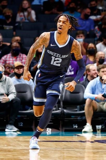 Ja Morant of the Memphis Grizzlies reacts following a basket during the first period of their game against the Charlotte Hornets at Spectrum Center...