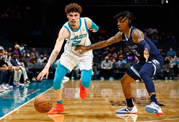 LaMelo Ball of the Charlotte Hornets dribbles against Ja Morant of the Memphis Grizzlies during the first period of their game at Spectrum Center on...