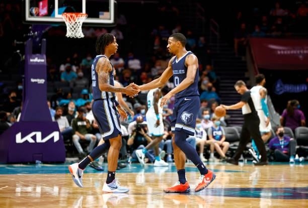 De'Anthony Melton and Ja Morant of the Memphis Grizzlies react following a basket during the first period of their game at Spectrum Center on October...