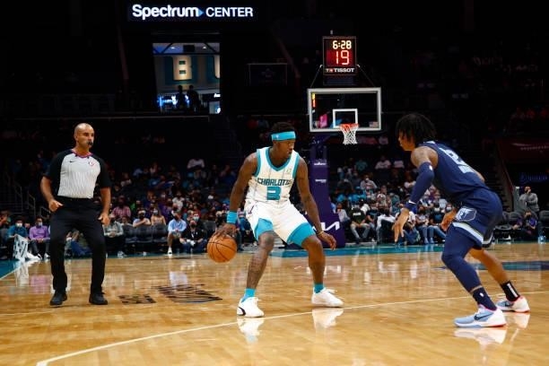 Terry Rozier of the Charlotte Hornets dribbles against Ja Morant of the Memphis Grizzlies during the first period of their game at Spectrum Center on...