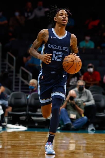 Ja Morant of the Memphis Grizzlies brings the ball up court during the third period of their game against the Charlotte Hornets at Spectrum Center on...