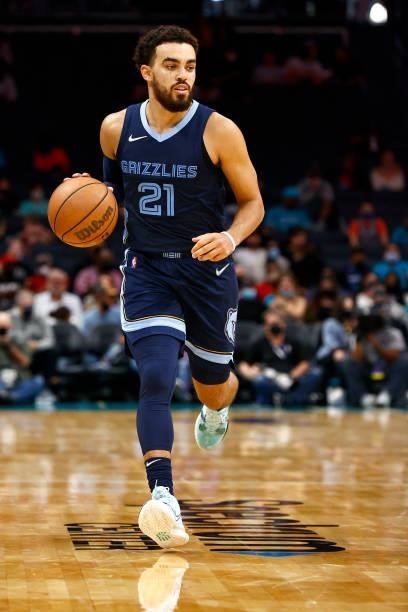 Tyus Jones of the Memphis Grizzlies brings the ball up court during the third period of their game against the Charlotte Hornets at Spectrum Center...