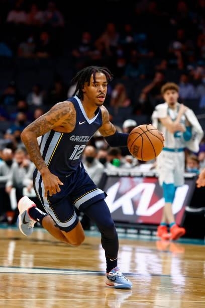 Ja Morant of the Memphis Grizzlies brings the ball up court during the third period of their game against the Charlotte Hornets at Spectrum Center on...