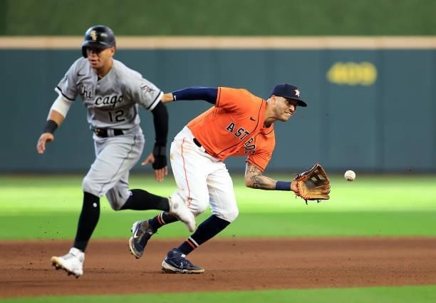 Carlos Correa of the Houston Astros fields the ball as Cesar Hernandez of the Chicago White Sox runs toward third during the 9th inning of Game 2 of...