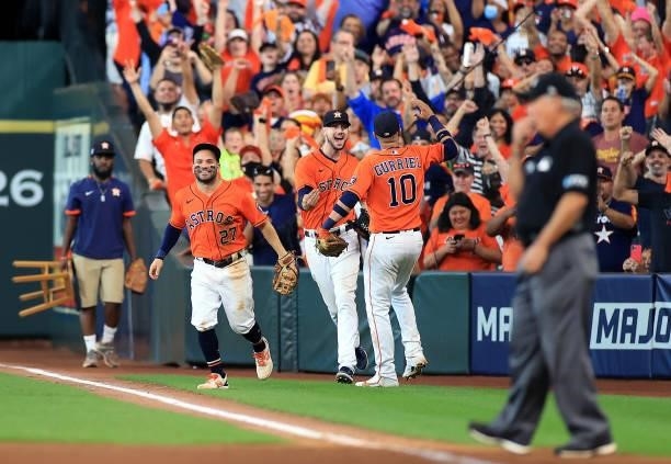 Jose Altuve, Kyle Tucker, and Yuli Gurriel of the Houston Astros celebrate after the final out as the Astros defeat the Chicago White Sox 9-4 to win...