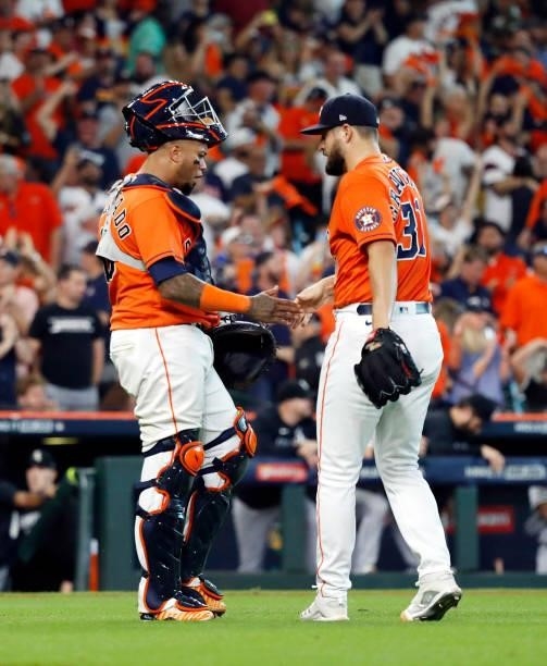 Closing pitcher Kendall Graveman of the Houston Astros is congratulated by Martin Maldonado after the final out as the Astros defeat the Chicago...