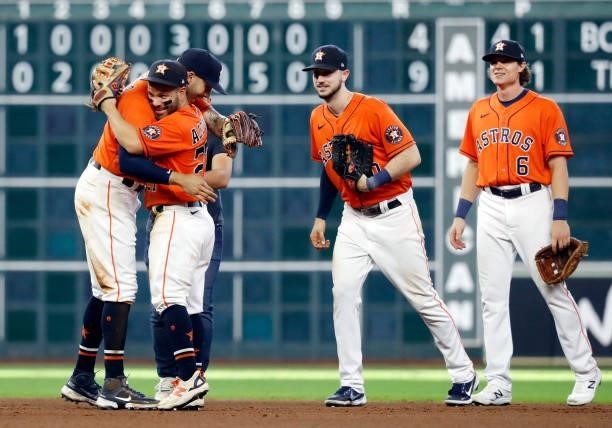 Jose Altuve of the Houston Astros celebrates with Carlos Correa, Kyle Tucker, and Jake Meyers as the Astros defeat the Chicago White Sox 9-4 to win...