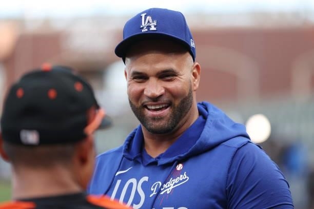 Albert Pujols of the Los Angeles Dodgers talks with Donovan Solano of the San Francisco Giants prior to Game 1 of the National League Division Series...