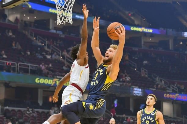 Collin Sexton of the Cleveland Cavaliers tries to stop Domantas Sabonis of the Indiana Pacers during the first quarter at Rocket Mortgage Fieldhouse...