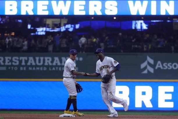 Lorenzo Cain and Kolten Wong of the Milwaukee Brewers celebrate a win over the Atlanta Braves during game 1 of the National League Division Series at...
