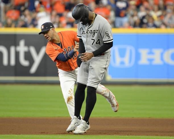 Yuli Gurriel of the Houston Astros tags out Eloy Jimenez of the Chicago White Sox in the fourth inning of Game Two of the American League Division...