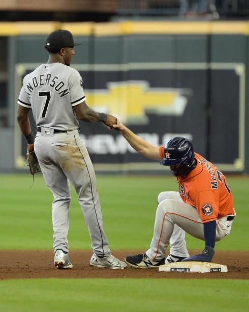 Tim Anderson of the Chicago White Sox helps Chas McCormick of the Houston Astros to his feet after McCormick was out on a double play in the sixth...