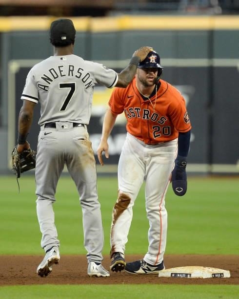 Tim Anderson of the Chicago White Sox helps Chas McCormick of the Houston Astros to his feet after McCormick was out on a double play in the sixth...