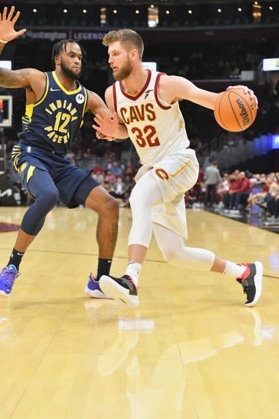 Oshae Brissett of the Indiana Pacers tries to stop Dean Wade of the Cleveland Cavaliers during the third quarter at Rocket Mortgage Fieldhouse on...