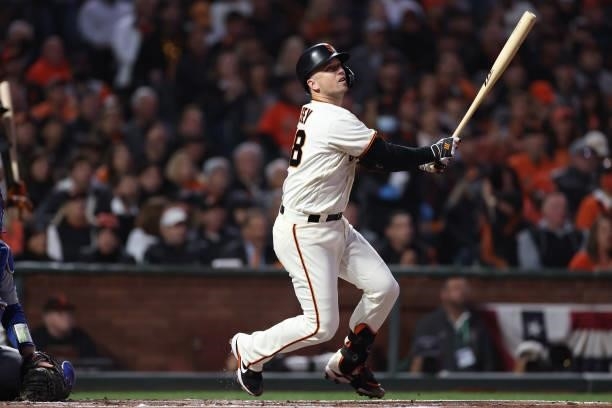 Buster Posey of the San Francisco Giants hits a two-run home run off Walker Buehler of the Los Angeles Dodgers during the first inning of Game 1 of...