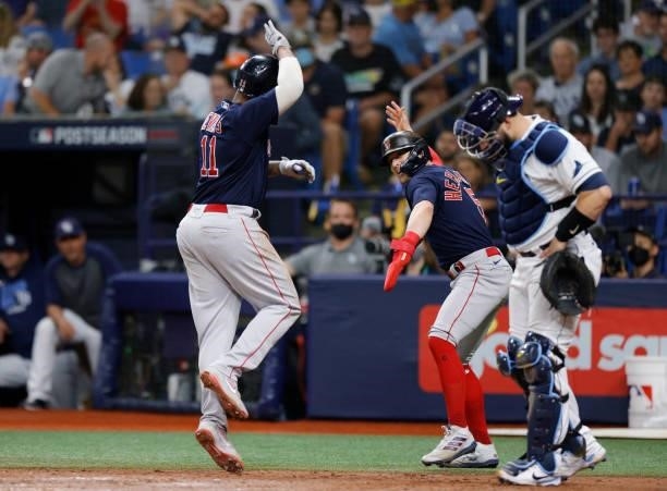 Rafael Devers of the Boston Red Sox celebrates his two-run homerun with Enrique Hernandez in the eighth inning against the Tampa Bay Rays during Game...