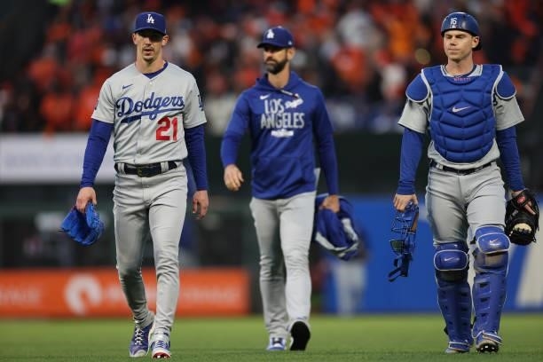 Walker Buehler, pitching coach Mark Prior, and Will Smith walk to the dugout prior to Game 1 of the National League Division Series against the San...