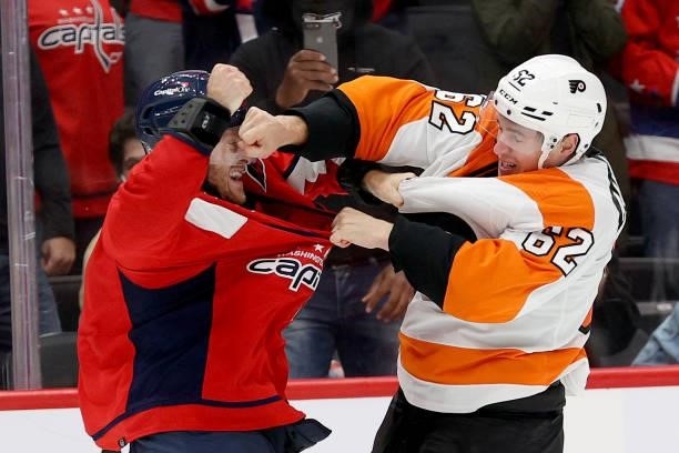 Nick Jensen of the Washington Capitals and Nicolas Aube-Kubel of the Philadelphia Flyers fight in the third period of a preseason game at Capital One...