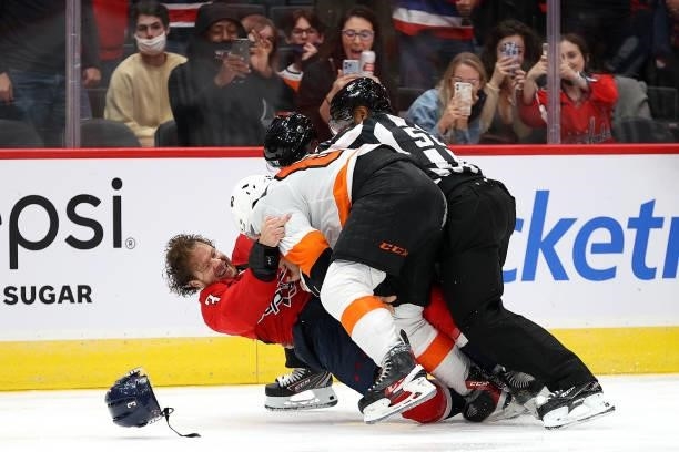 Nick Jensen of the Washington Capitals and Nicolas Aube-Kubel of the Philadelphia Flyers fight in the third period of a preseason game at Capital One...
