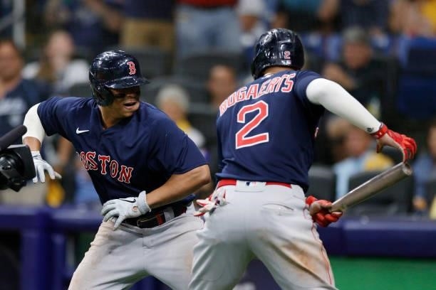 Rafael Devers of the Boston Red Sox celebrates his two-run homerun with Xander Bogaerts in the eighth inning against the Tampa Bay Rays during Game 2...