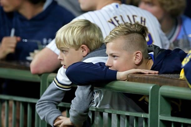 Two young Milwaukee Brewers fans watch Josh Hader warm up in the bullpen in the eighth inning against the Atlanta Braves during Game One of the...