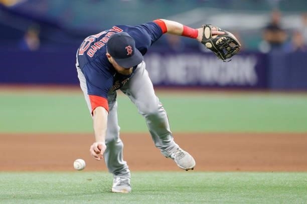 Christian Arroyo of the Boston Red Sox bobbles the ball on a single by Nelson Cruz of the Tampa Bay Rays in the eighth inning during Game 2 of the...