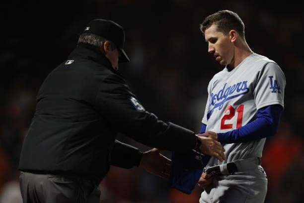 Walker Buehler of the Los Angeles Dodgers is checked for foreign substances by umpire Angel Hernandez against the San Francisco Giants during the...