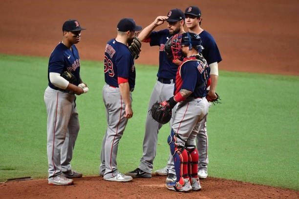 Matt Barnes of the Boston Red Sox is visited on the mound in the ninth inning against the Tampa Bay Rays during Game 2 of the American League...