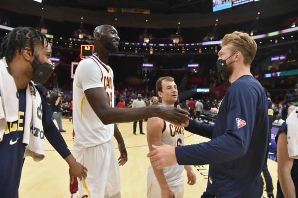 Tacko Fall of the Cleveland Cavaliers talks with Domantas Sabonis of the Indiana Pacers after the game at Rocket Mortgage Fieldhouse on October 08,...