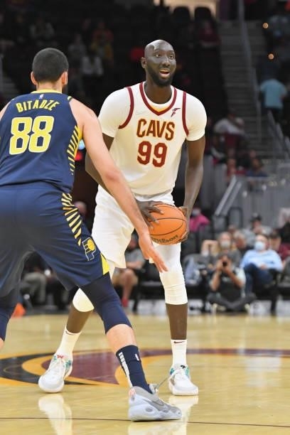 Tacko Fall of the Cleveland Cavaliers looks for a pass while under pressure from Goga Bitadze of the Indiana Pacers during the fourth quarter at...