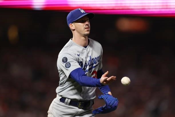 Walker Buehler of the Los Angeles Dodgers throws out a runner against the San Francisco Giants during the sixth inning of Game 1 of the National...