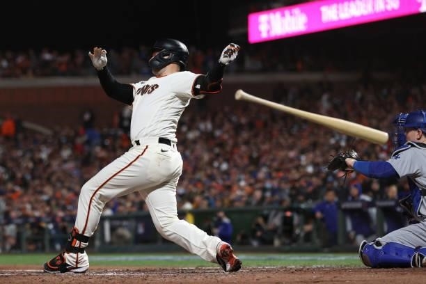 Buster Posey of the San Francisco Giants loses control of his bat as he strikes out against the Los Angeles Dodgers during the sixth inning of Game 1...
